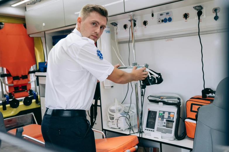 a man is standing in front of some electronics