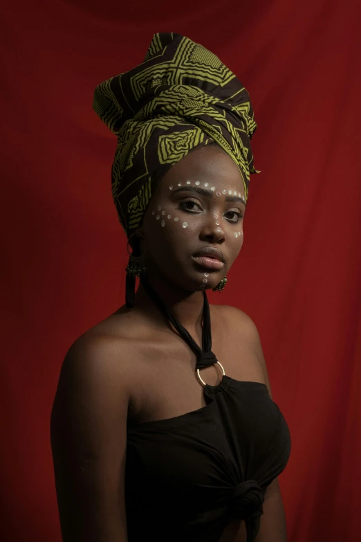 a woman wearing a turban with a hair bow in her hair