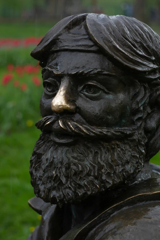 a bronze statue of a man with a beard