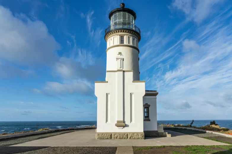 an observation tower near the ocean with a bright blue sky