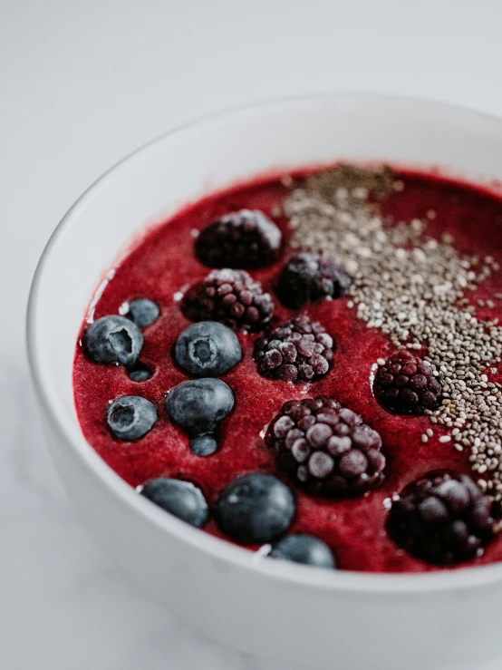 bowl of berry and oatmeal yogurt and a spoon