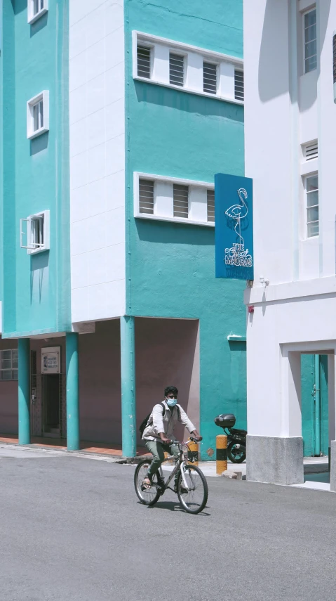 man riding a bicycle in front of a building