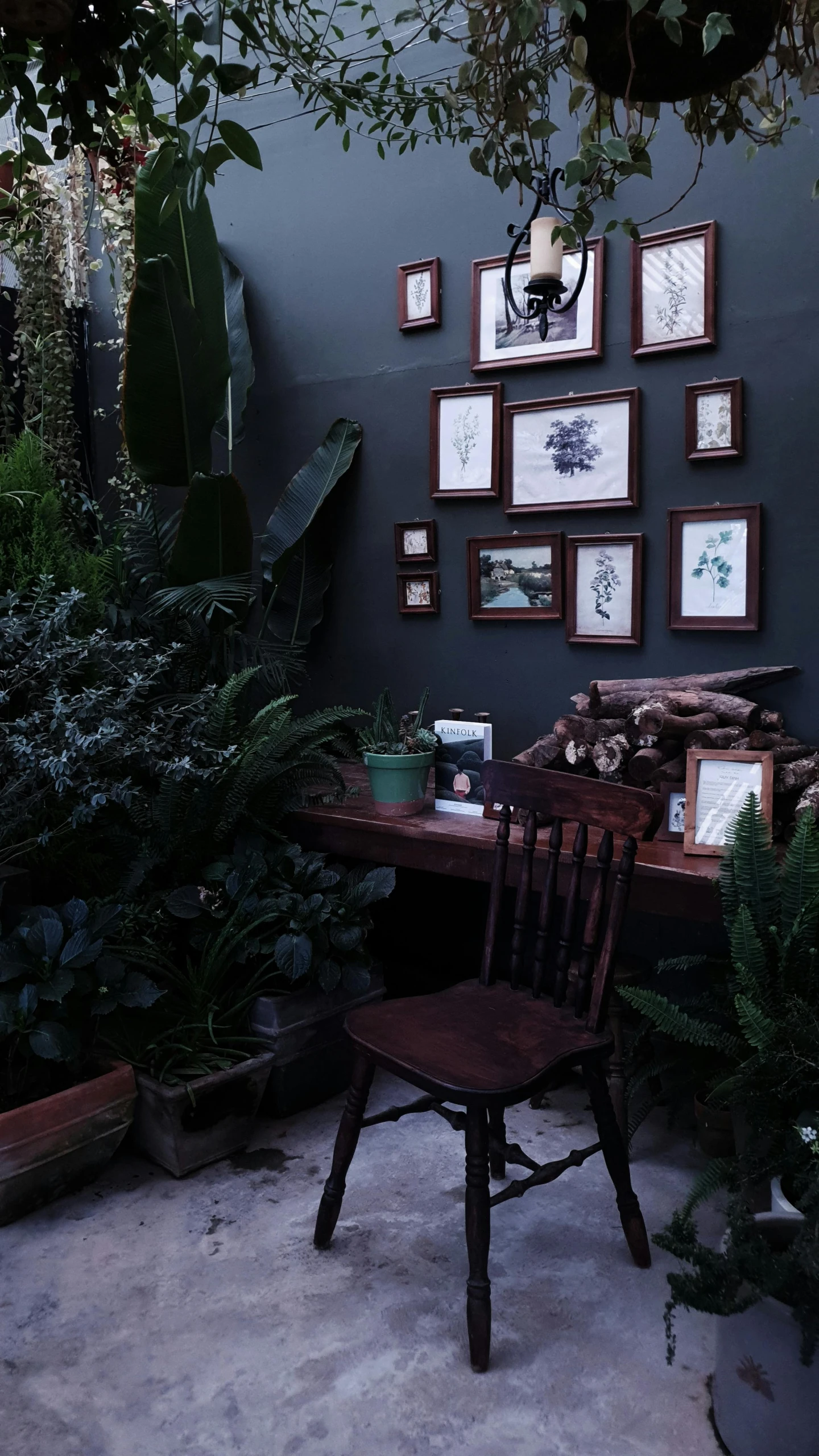 a dark table with many framed pictures on the wall