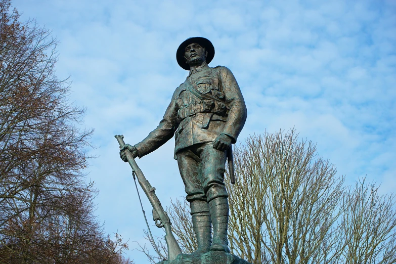 statue of soldier with rifle standing in foreground