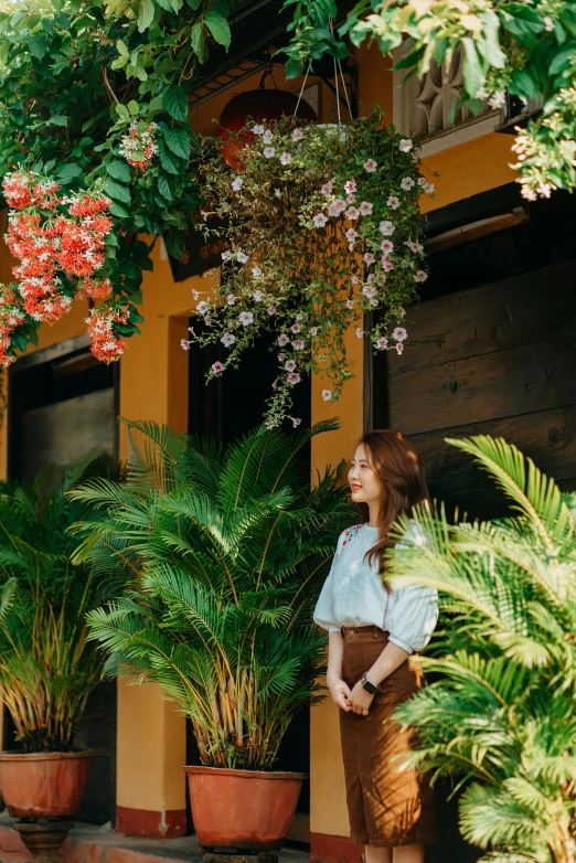 the woman is looking at some plants outside