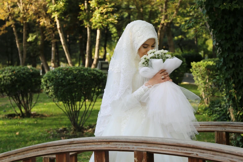 bride in white dress wearing white veil with a bouquet