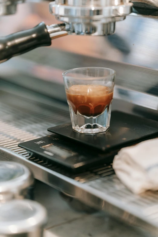 a coffee is being made in a espresso machine