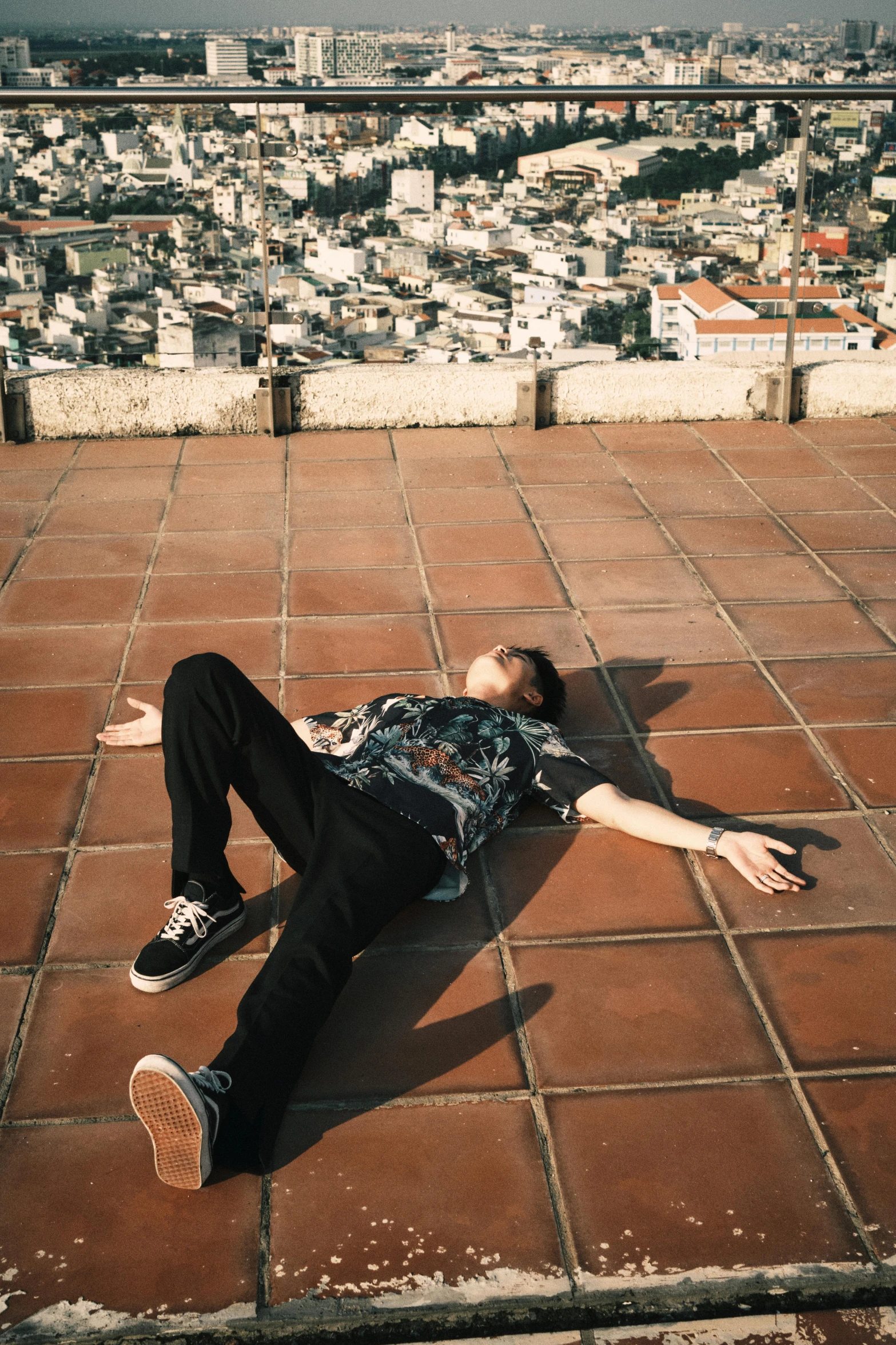 the young man lies down on the ground while doing tricks