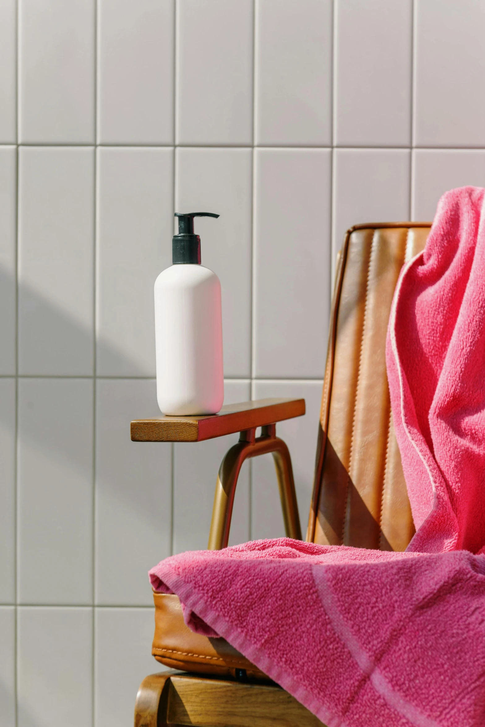 an orange towel and pink soap on top of a chair