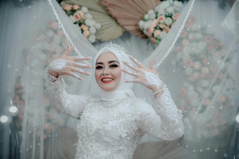 a woman wearing white, veiled head piece and jewelry