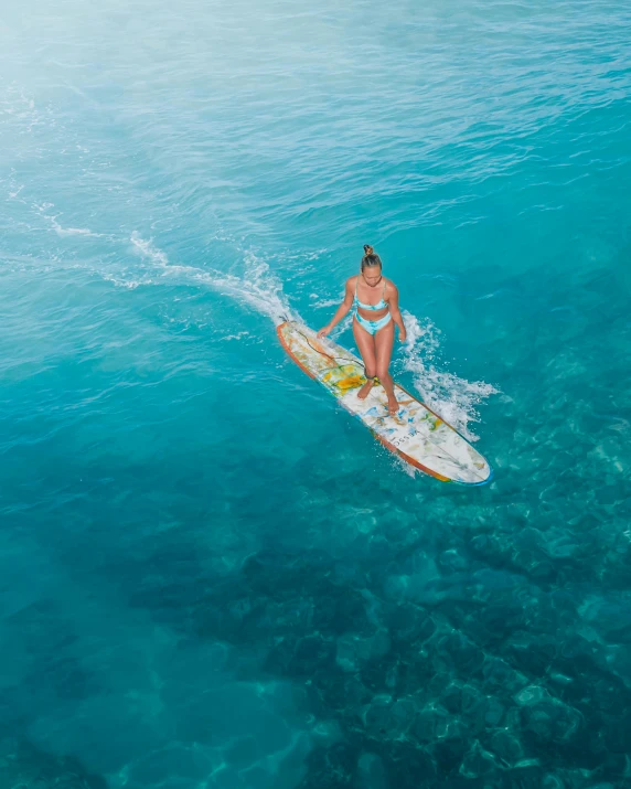 a person on a surfboard in the middle of the ocean