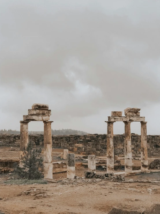 ancient ruins and pillars in an empty plain