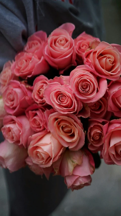 a person with some pink flowers in their hands