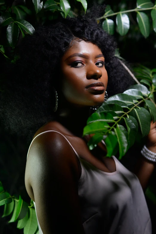 an image of a woman that is hiding behind plants