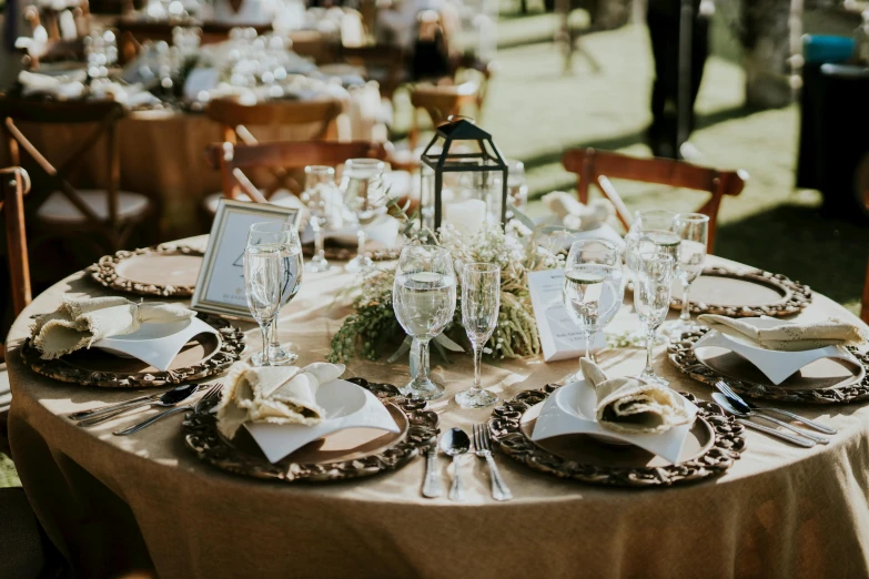 a table set for a formal dinner outside