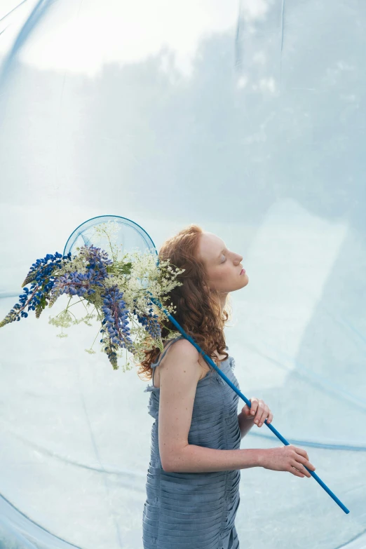 a woman holding a vase in front of her face