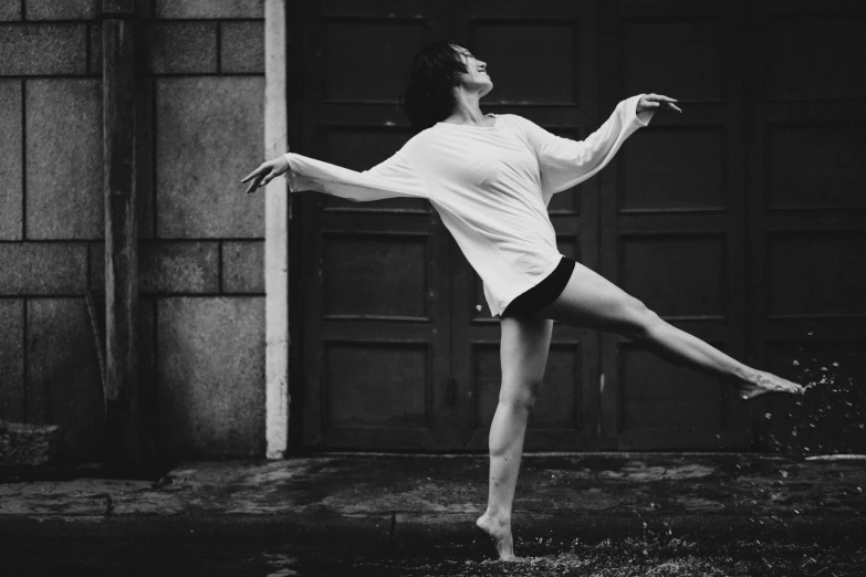 a girl in the rain, in front of a garage