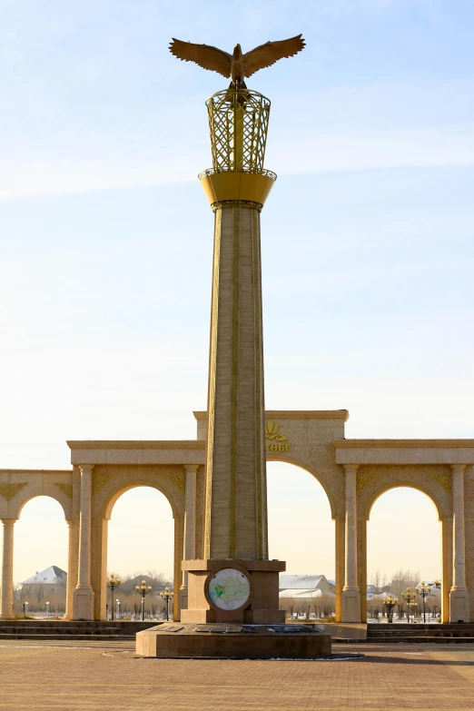 an elaborate clock on top of a stone column