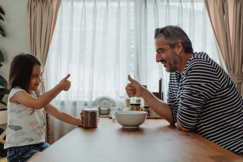 a man and  sit at a table having breakfast