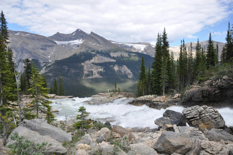 a river flows into a lake surrounded by mountains