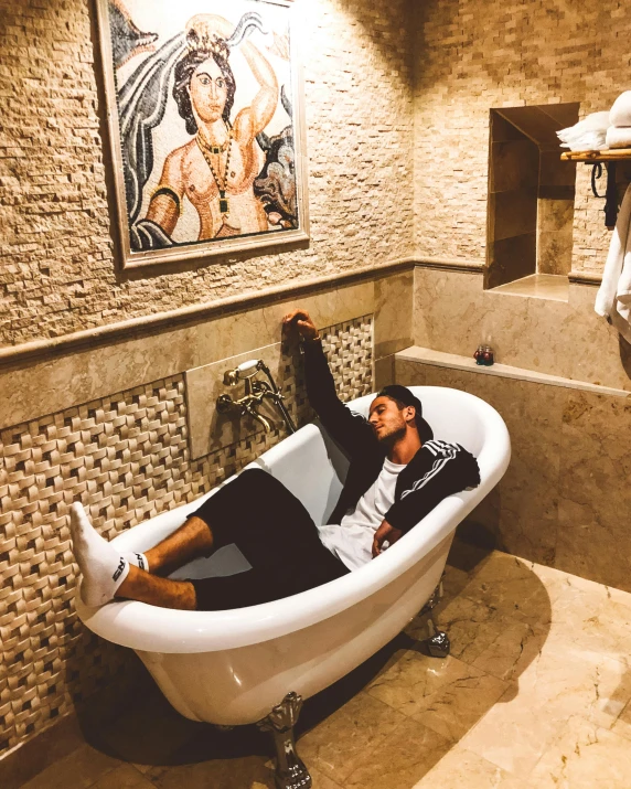 a person laying in an old fashioned claw foot tub