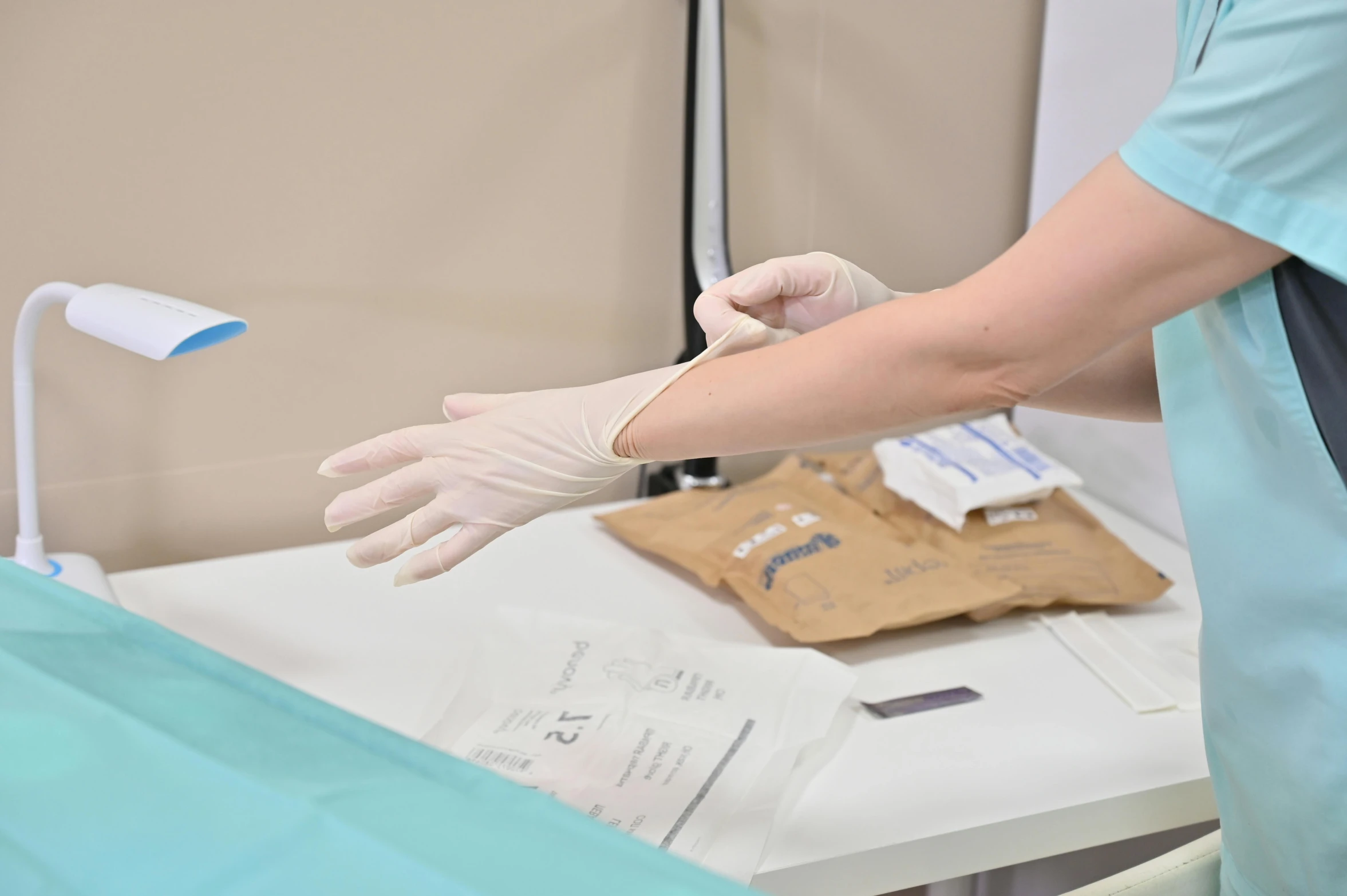 a medical staff wearing gloves and gloves checking the chest of a patient