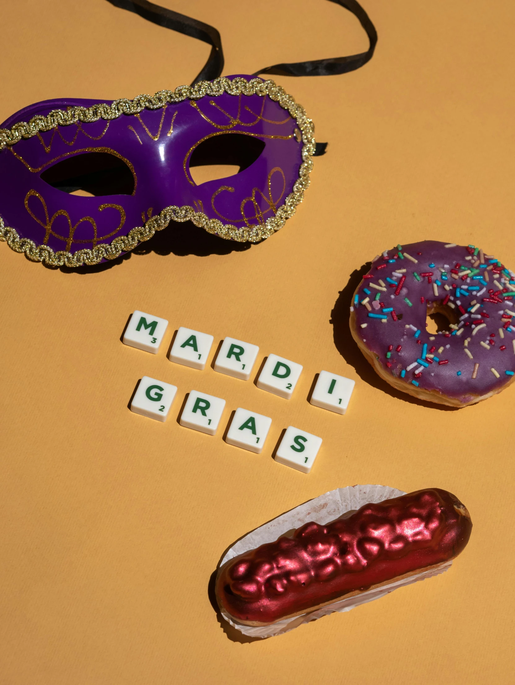 a mardi gras mask, doughnut, and spelled word search