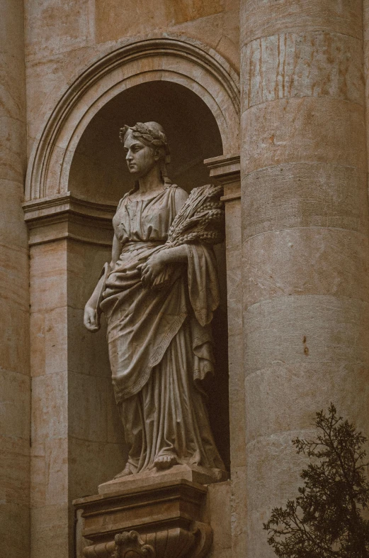 a statue of a woman is near a window