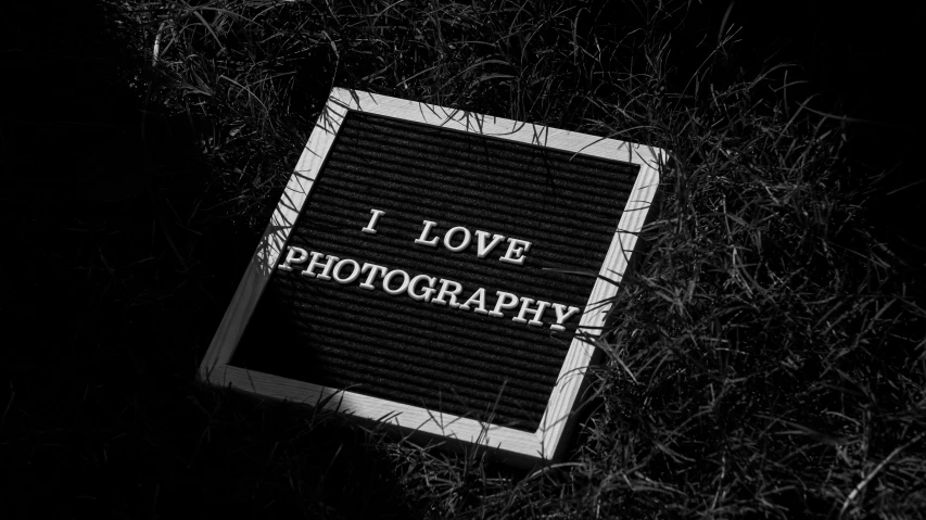 an i love pography sign in a grassy area