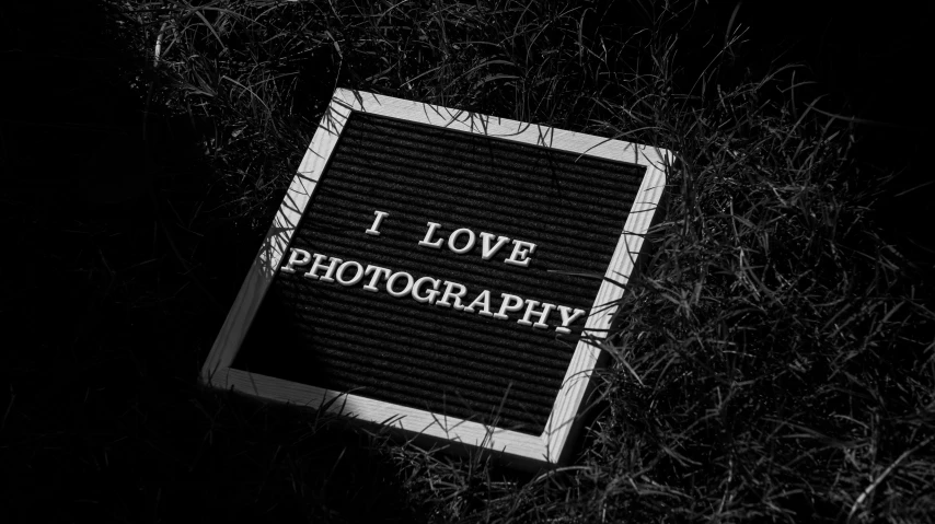 an i love pography sign in a grassy area
