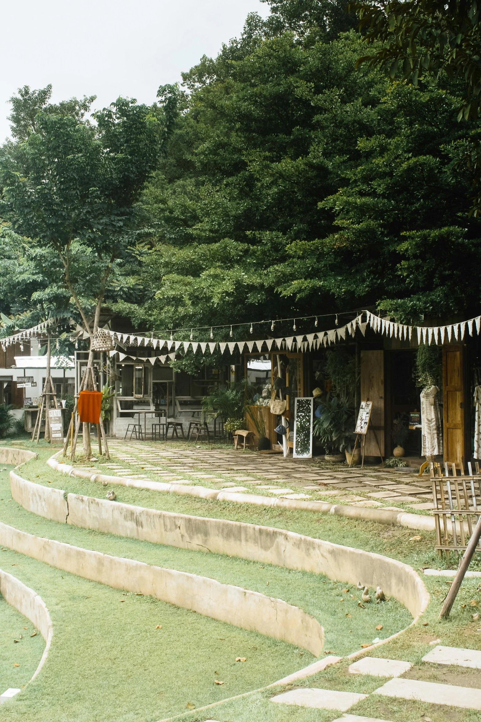 some buildings on the grass near some trees