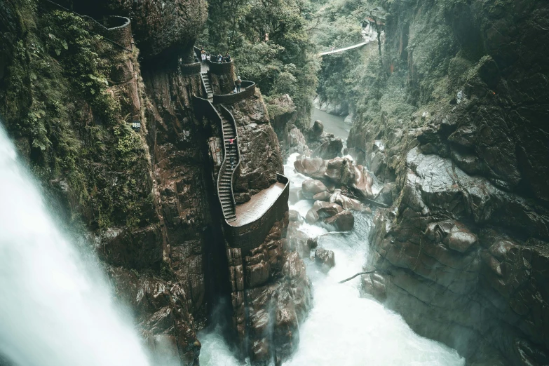 the people walk a wire suspended walkway over the falls