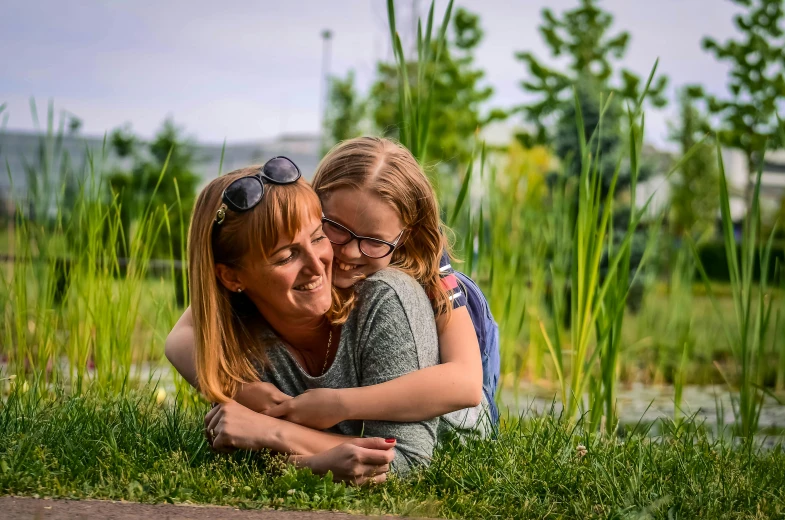 mother and daughter in a grassy park