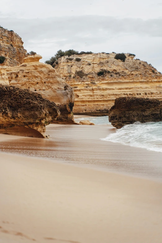 a rocky landscape next to an ocean filled with water