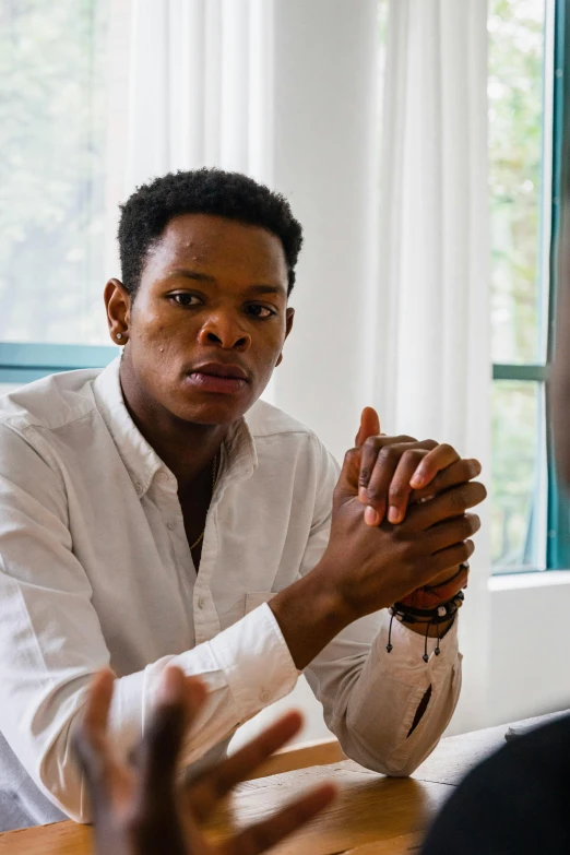 the man is praying while being interviewed