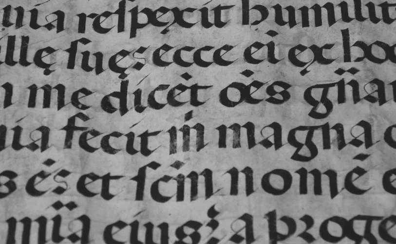 a close up of a mcript text in black ink