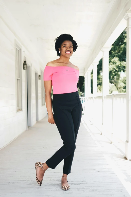 a smiling woman in pink top posing for a po