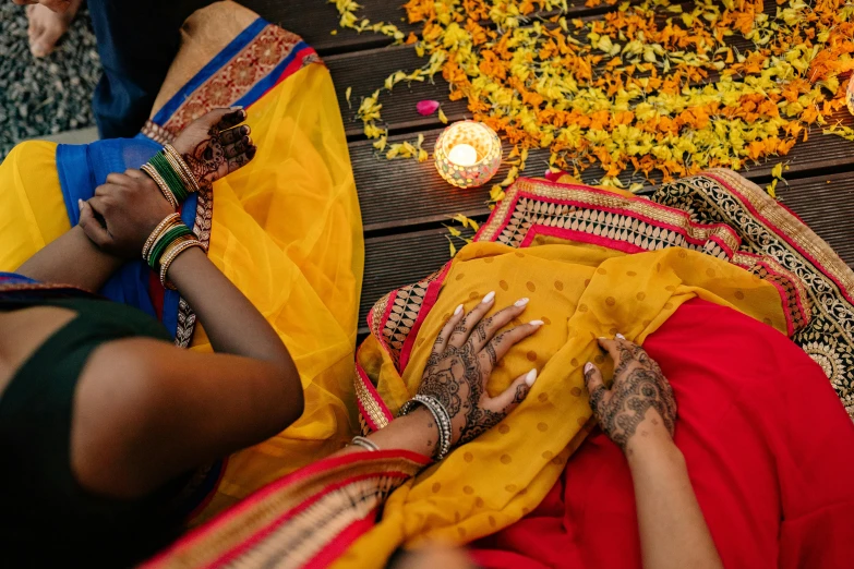 women getting married on flower petals and lights