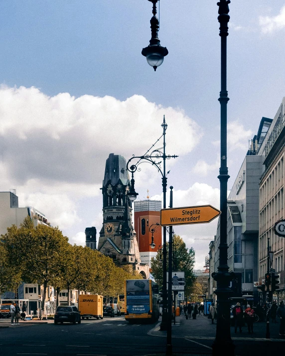 a street lamp sitting above a street filled with traffic