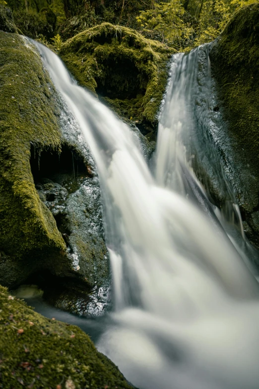 small waterfall in the woods during the day