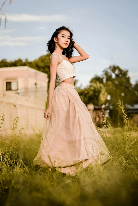 a girl in a long skirt poses for the camera