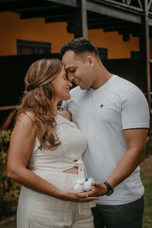 a couple stands close together with their bottles