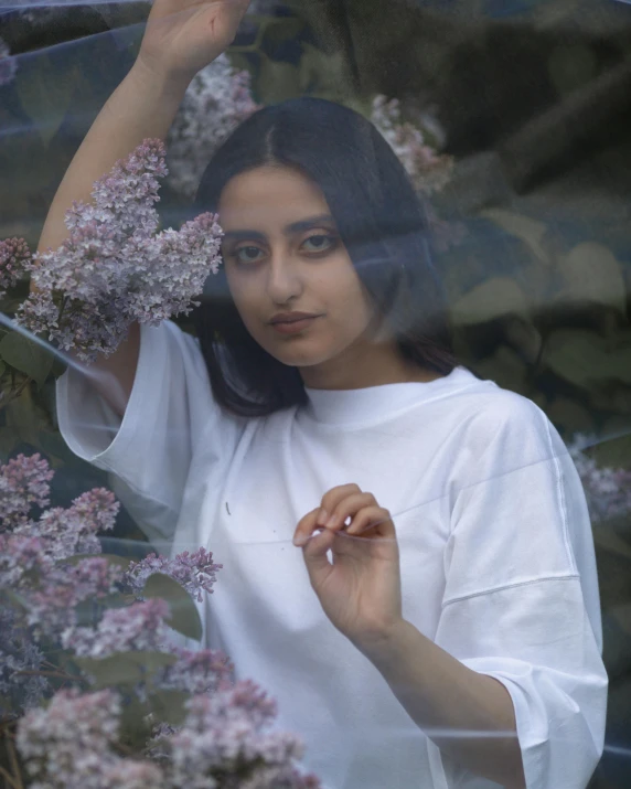 a beautiful young woman holding an umbrella over her head