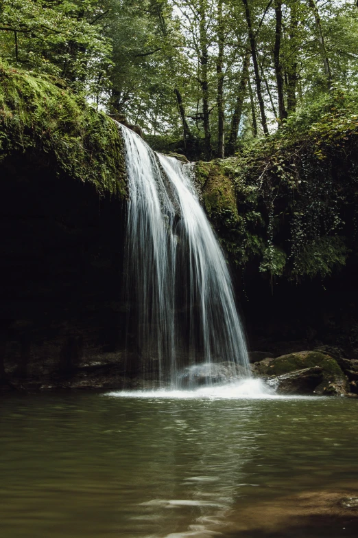 water falling off a waterfall into a creek