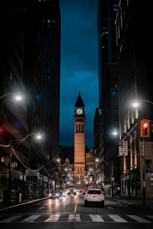 street lights are on and buildings glow in the background