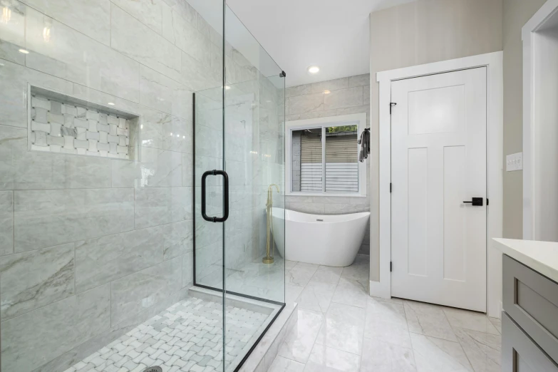 the bathroom features white tiles and marble walls