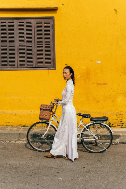 a woman with a bicycle on the road