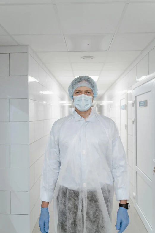 man wearing protective face mask and gloves standing in tunnel