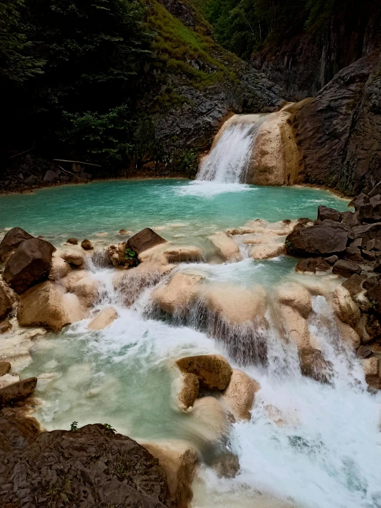 a river that has rocks in it and green water