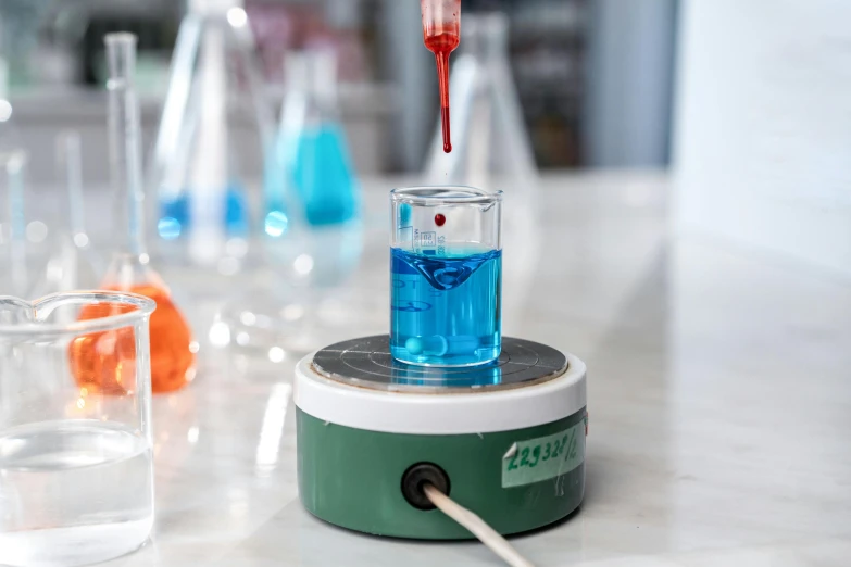 a table with flasks filled with various colored liquids